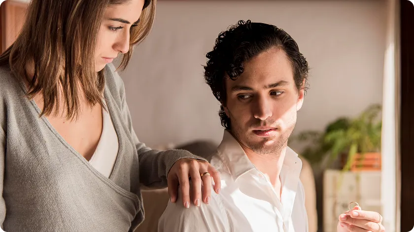 A woman comforting a man, where the man's aloof expression highlights narcissistic characteristics, showing emotional detachment and self-centeredness in relationships.