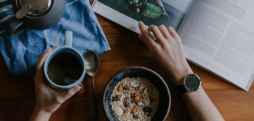 A vibrant morning scene showcasing a healthy morning routine with exercise, meditation, and a nutritious breakfast in a bright, modern setting.