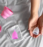 Woman holding emergency contraceptive pills discussing side effects and timely pregnancy prevention.