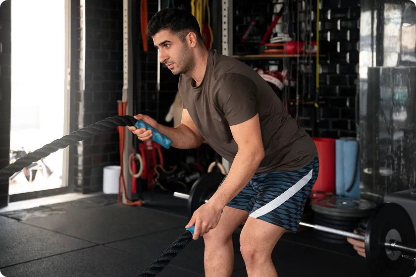 Trainer correcting form during gym workout routine for men with weight lifting.