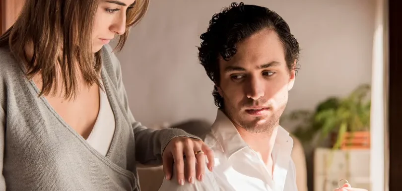 A woman comforting a man, where the man's aloof expression highlights narcissistic characteristics, showing emotional detachment and self-centeredness in relationships.