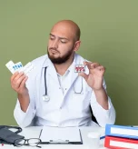 A doctor holding two pill containers while considering the impact of lupus treatments, symbolizing the complexity of managing azithromycin side effects.