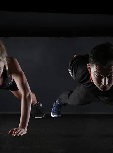 Couple performing push-ups for daily workout routine strength training