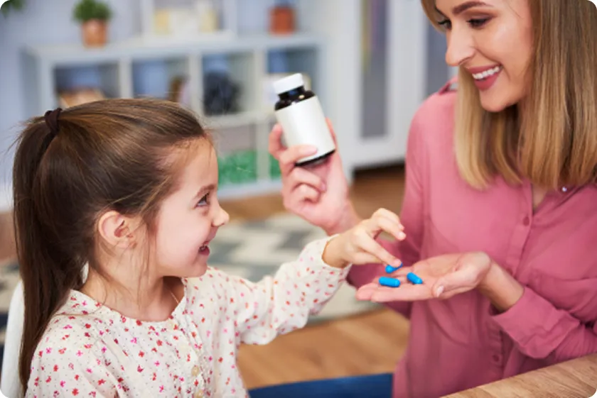 Mother giving child magnesium glycinate kids supplements for wellness
