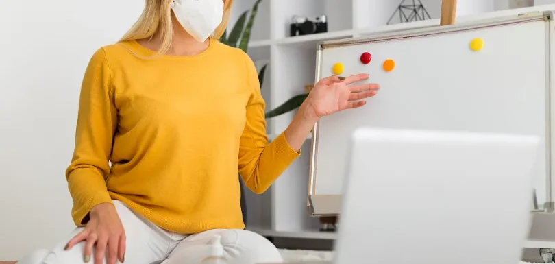 Masked teacher explains harmful microorganisms and infection vs disease online.