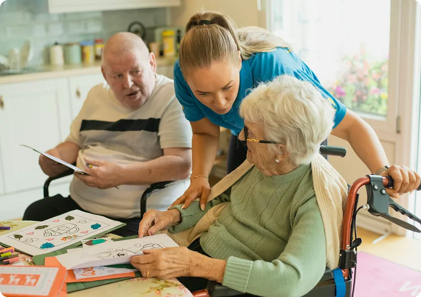 Caregiver supporting elderly woman at home, facilitating activities for dementia patients at home.