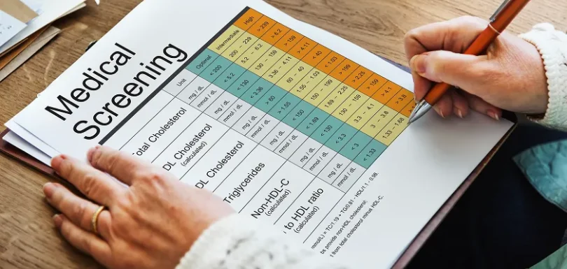 Person reviewing medical screening chart with statin potency chart and dosage insights.