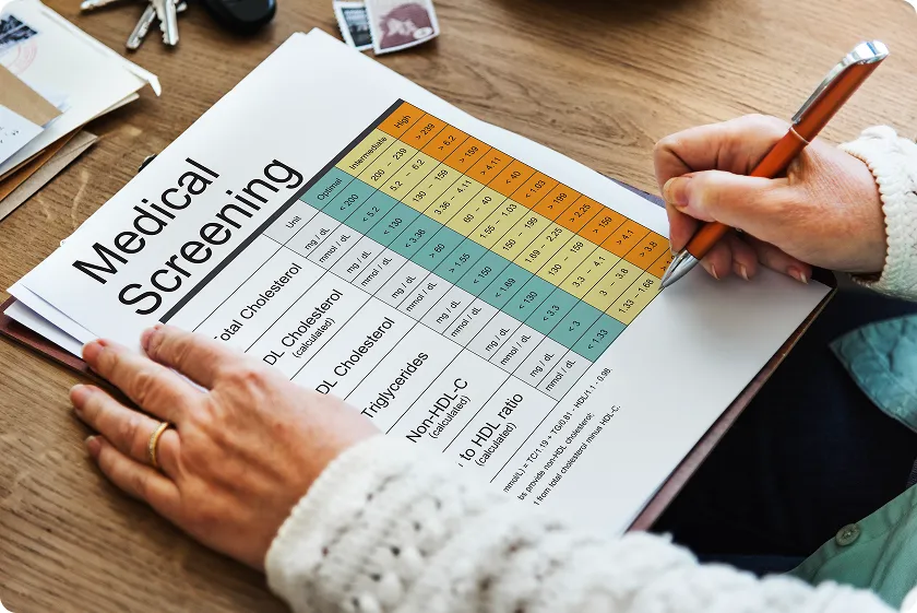 Person reviewing medical screening chart with statin potency chart and dosage insights.