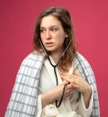 A worried woman holding a stethoscope to check for signs of heart failure in women.