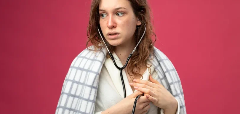 A worried woman holding a stethoscope to check for signs of heart failure in women.