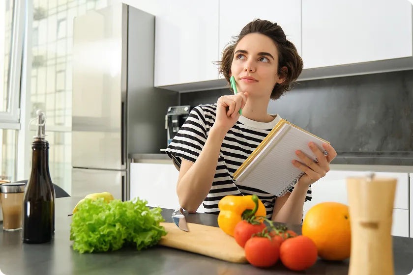 A woman planning fresh meals to discover how to increase your appetite.