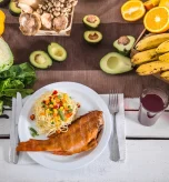 Table spread featuring cooked fish and pasta as foods good for diverticulitis.