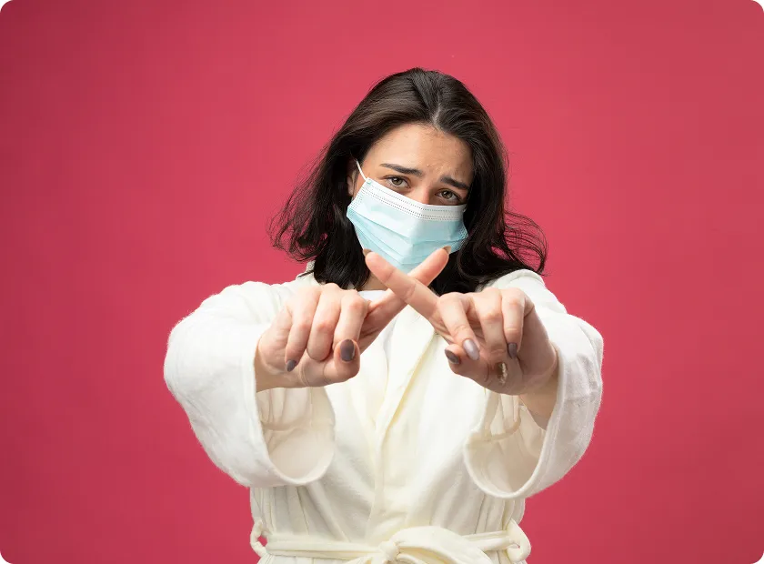 Masked woman signals caution about norovirus first symptoms and exposure