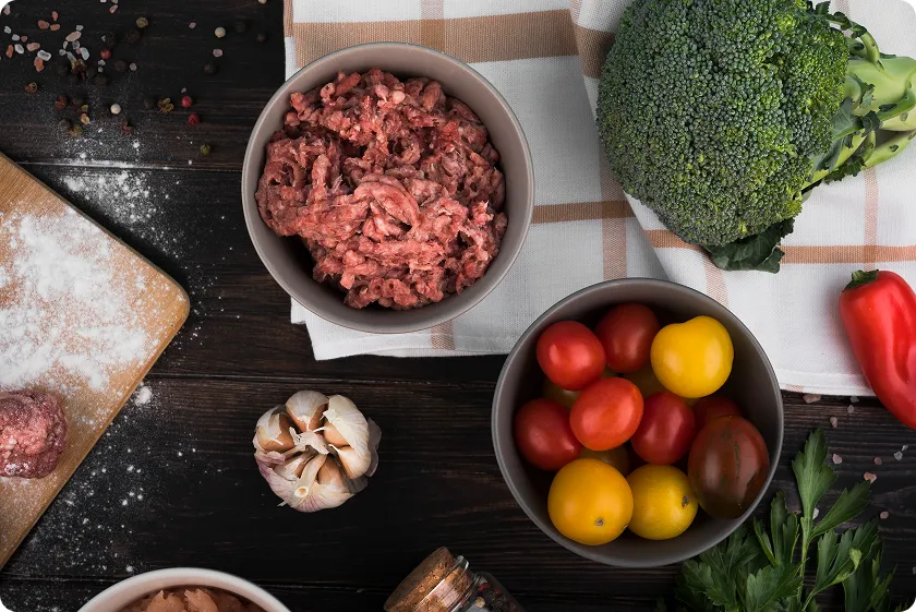 Raw beef bowl with vegetables for ground beef nutrition planning