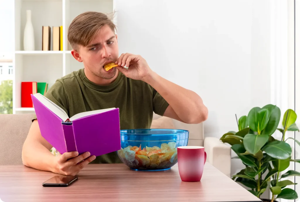 Distracted snacking while reading, which is a common reason for loss of appetite.