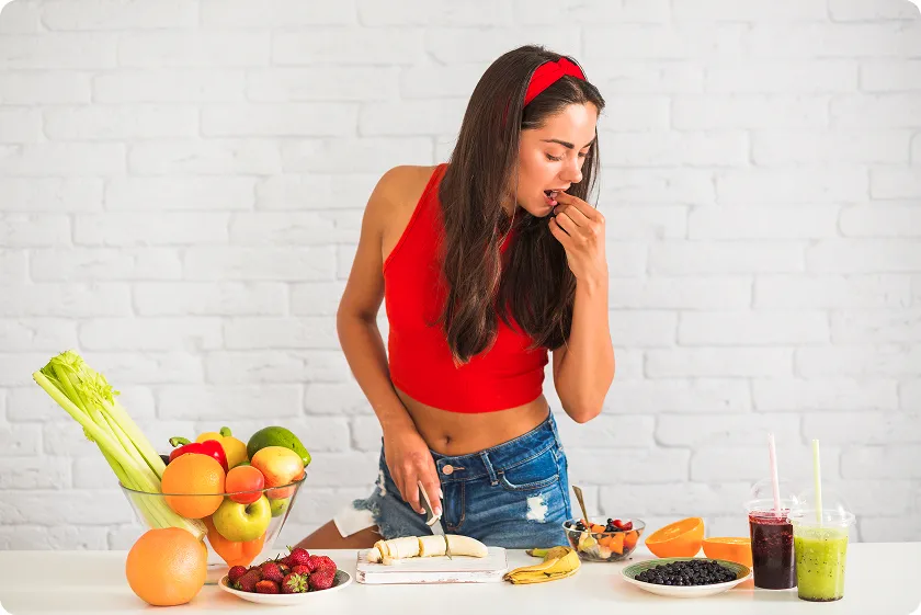 Woman preparing fresh fruit snacks including foods good for diverticulitis symptoms.