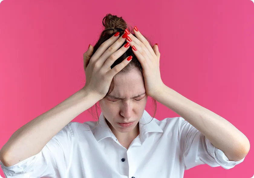 Young woman clutching head, signs of a silent stroke in a woman