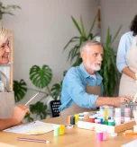 Elderly man learning daily routine schedule with caregiver support at home.