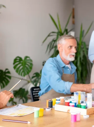 Elderly man learning daily routine schedule with caregiver support at home.