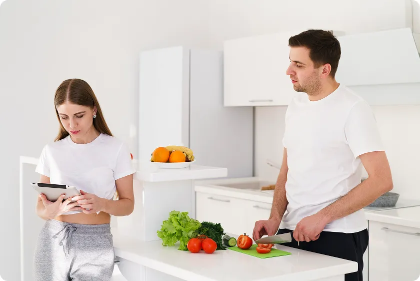 Couple following a diverticulitis soft diet by preparing easy-to-digest vegetable meals.