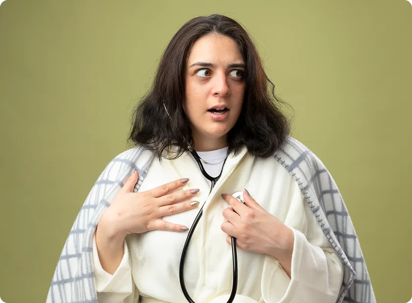 Anxious young woman uses a stethoscope illustrating core symptoms of heart failure in women.