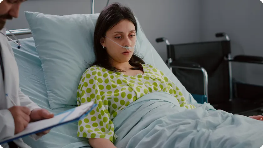 A patient receives medical care in a hospital bed, managing a severe flare affecting lupus life expectancy.