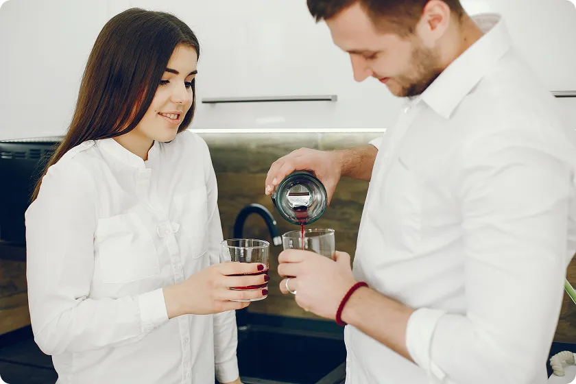 Couple pouring wine, considering at what age should you stop drinking alcohol