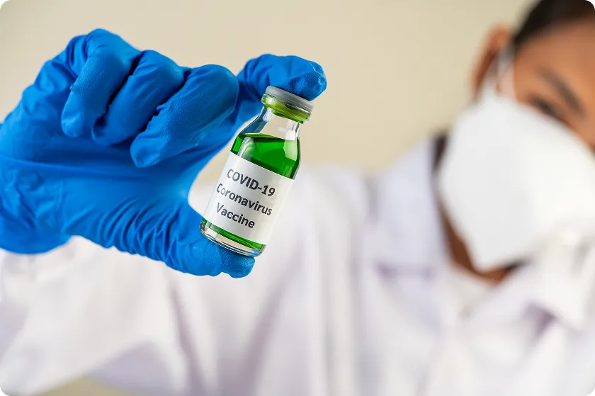 Researcher holds vaccine against harmful microorganisms; are viruses microbes explained.
