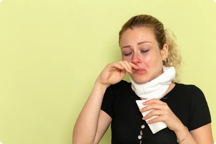 Young woman with a fever and cold, potential lupus symptoms in children.