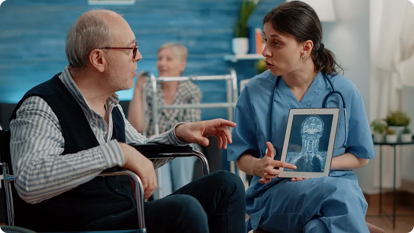 Nurse explaining a dementia care plan using a brain scan to patient.