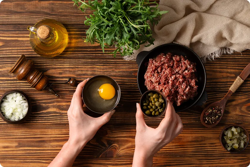 Ground beef nutrition ingredients prepared with egg, capers, onions, herbs