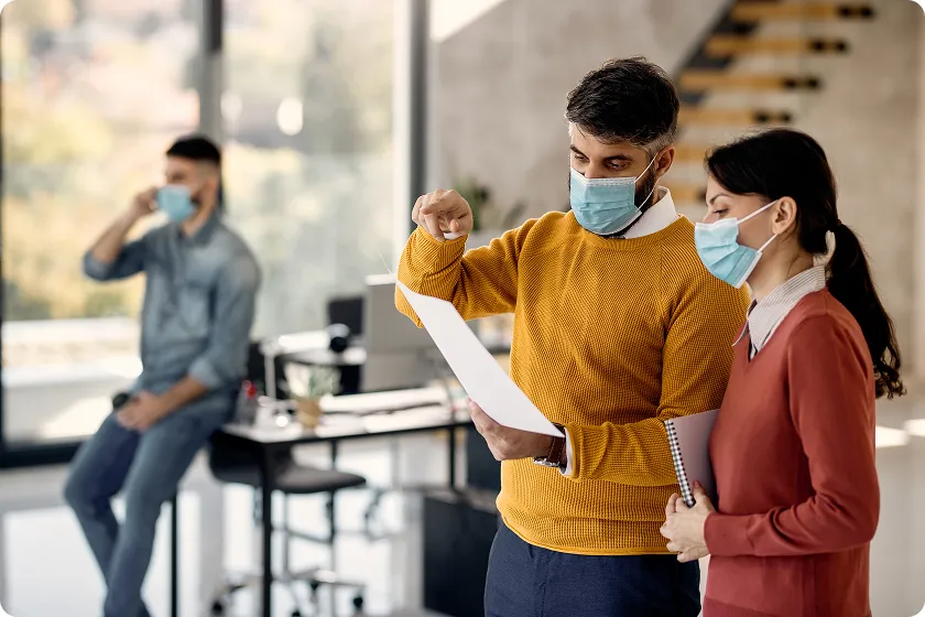 Masked coworkers discuss incubation of norovirus after possible workplace exposure