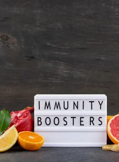 Citrus fruits and ginger around an immunity boosters sign representing acquired immunity definition.