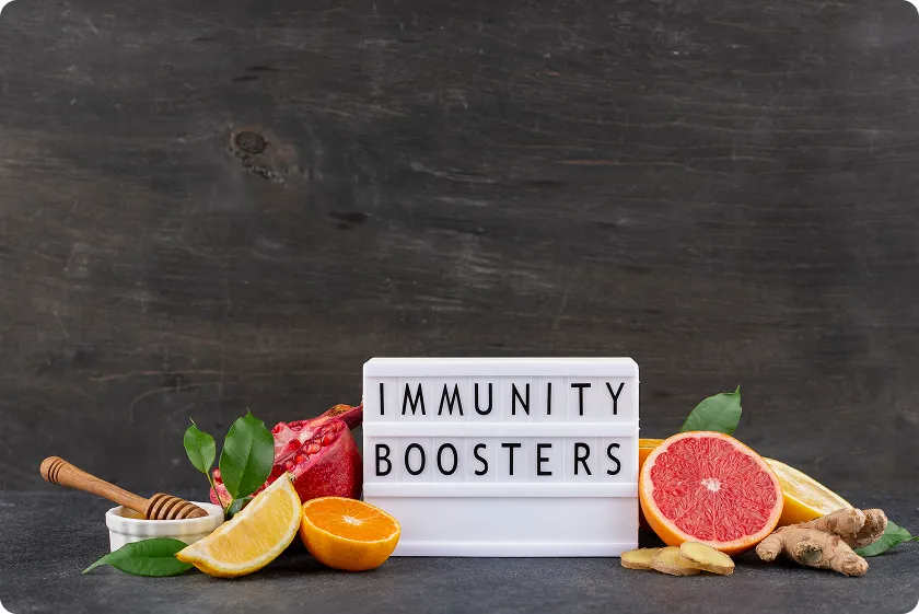 Citrus fruits and ginger around an immunity boosters sign representing acquired immunity definition.