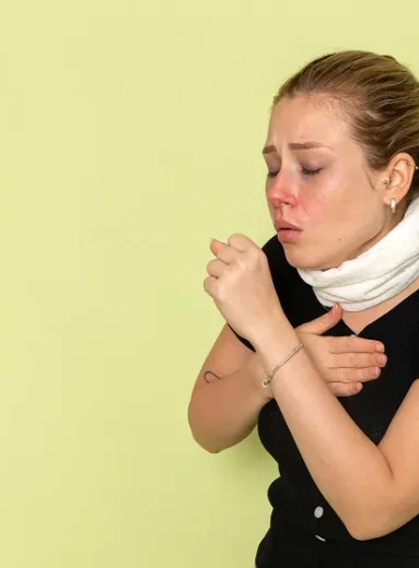 2 Woman coughing and covering throat due to allergy attack and throat allergy symptoms