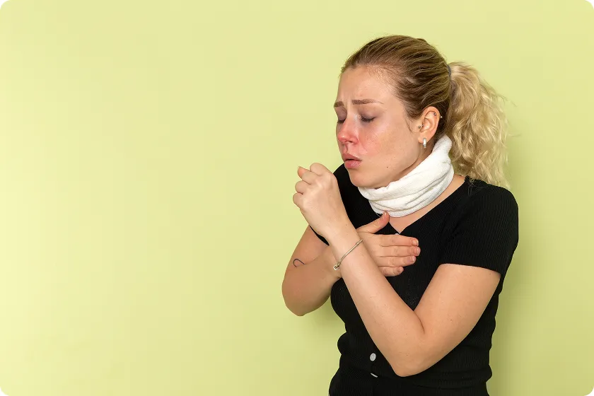 Woman coughing and covering throat due to allergy attack and throat allergy symptoms