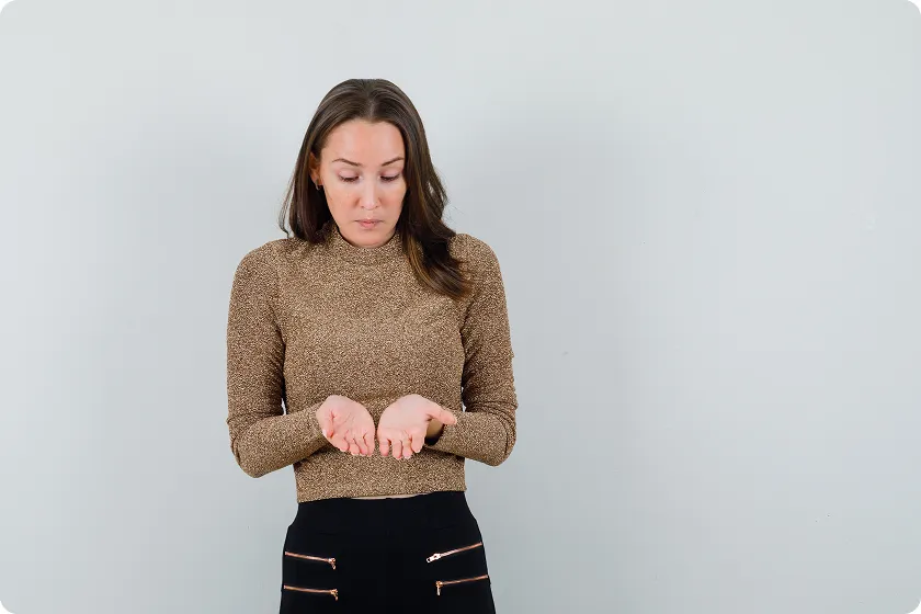 Woman checking hands for Crohn's disease skin rash changes