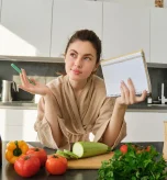 Woman planning her healthy grocery list and meals to follow a diverticulosis diet.