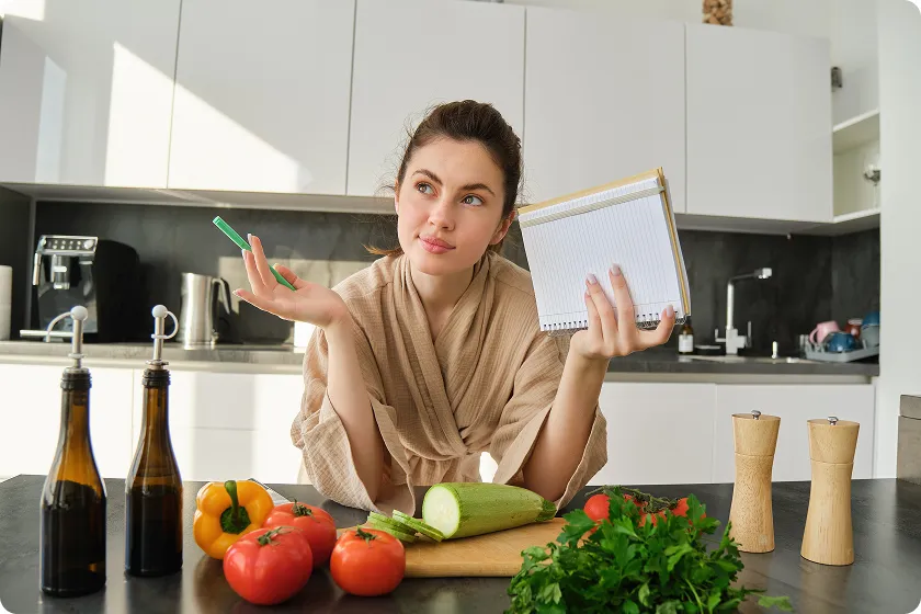 Woman planning her healthy grocery list and meals to follow a diverticulosis diet.