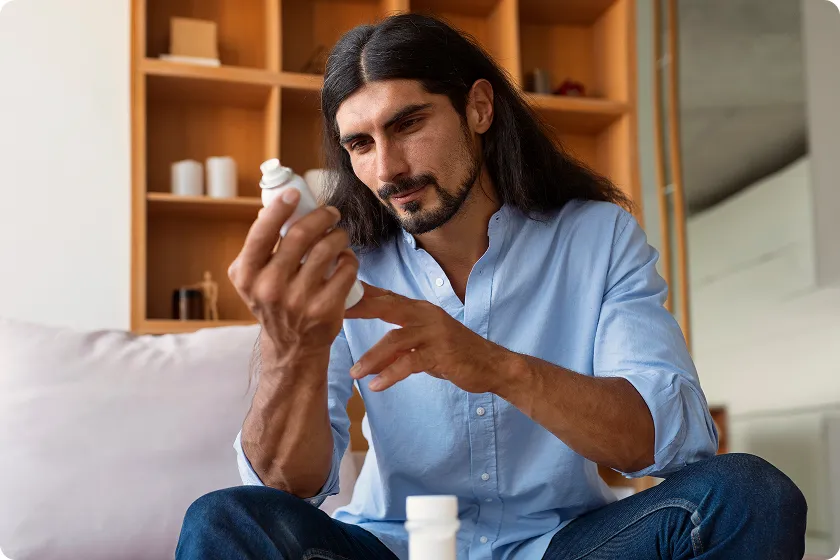 Patient prepares sublingual immunotherapy tablet for allergy drops routine