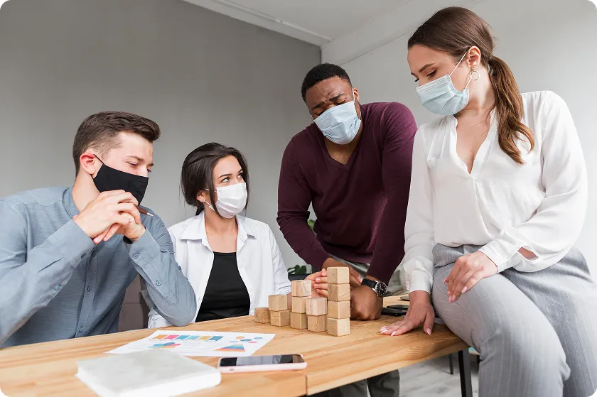 Masked colleagues collaborating to represent the second line of defense of the immune system.