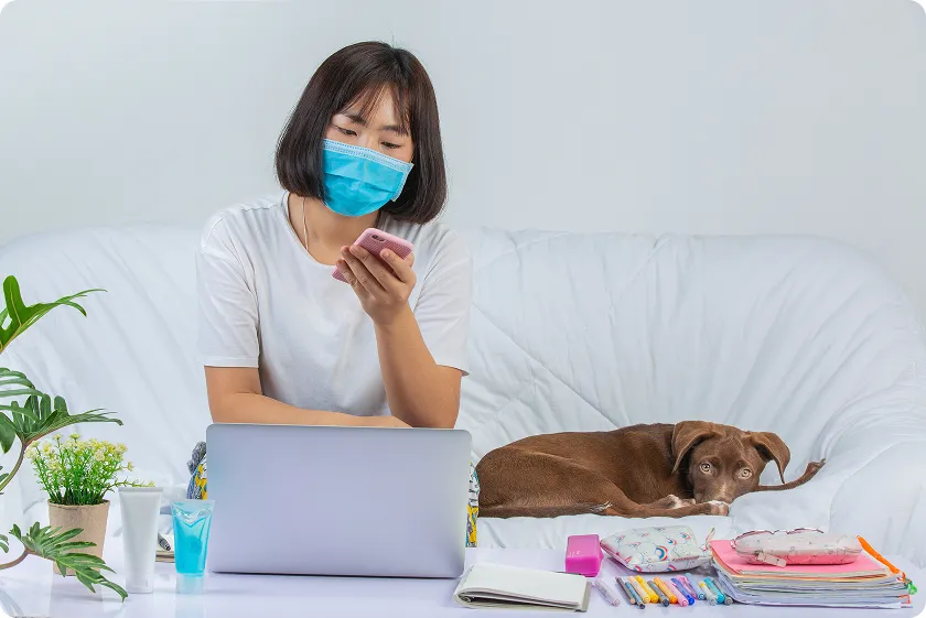 Young woman using phone while dog rests nearby, monitoring pet dander allergy symptoms