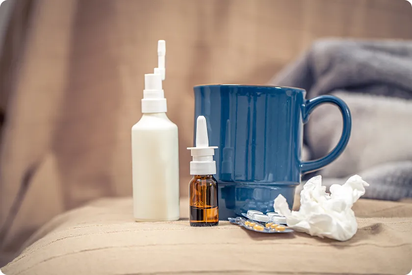 Woman at desk pointing to sublingual immunotherapy allergy drops and documents
