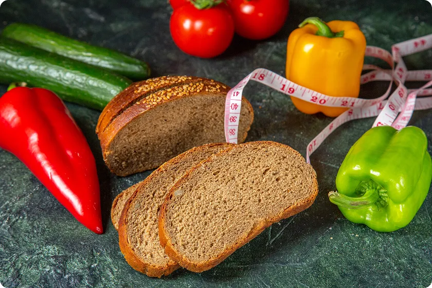 Sliced whole grain bread representing healthy foods high in carbs and low in calories.