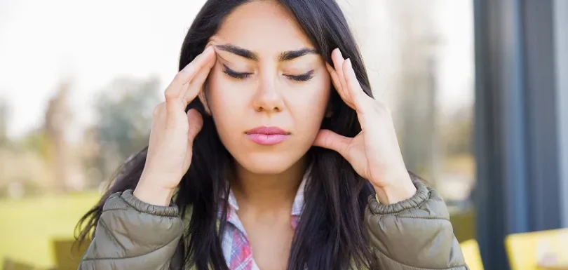 Woman learning what helps migraines to manage headache triggers