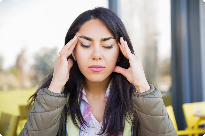 Woman learning what helps migraines to manage headache triggers