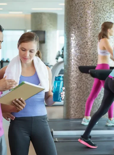 Fitness trainer explains cardio workout program for weight loss.