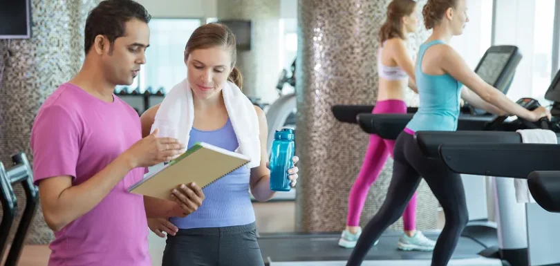 Fitness trainer explains cardio workout program for weight loss.