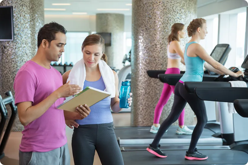 Fitness trainer explains cardio workout program for weight loss.