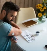 Person checking health readings to understand diabetes and fatigue symptoms